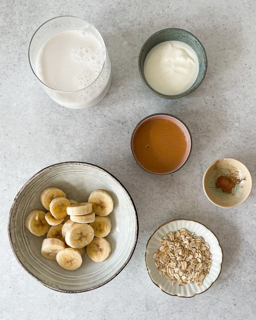 bowls of ingredients, milk butter, yoghurt, nut butter, oats, cinnamon and banana